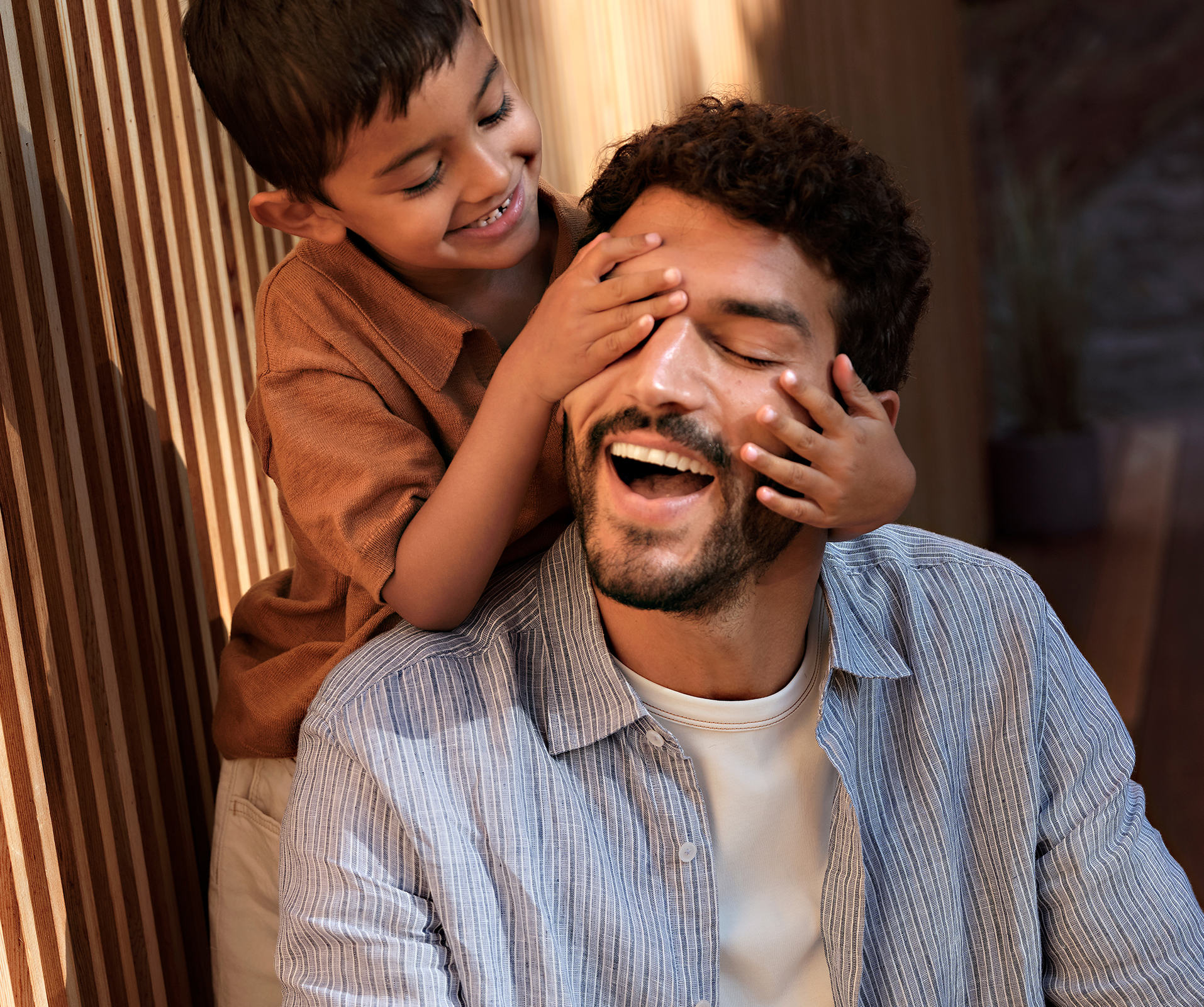 a boy touching a man's face