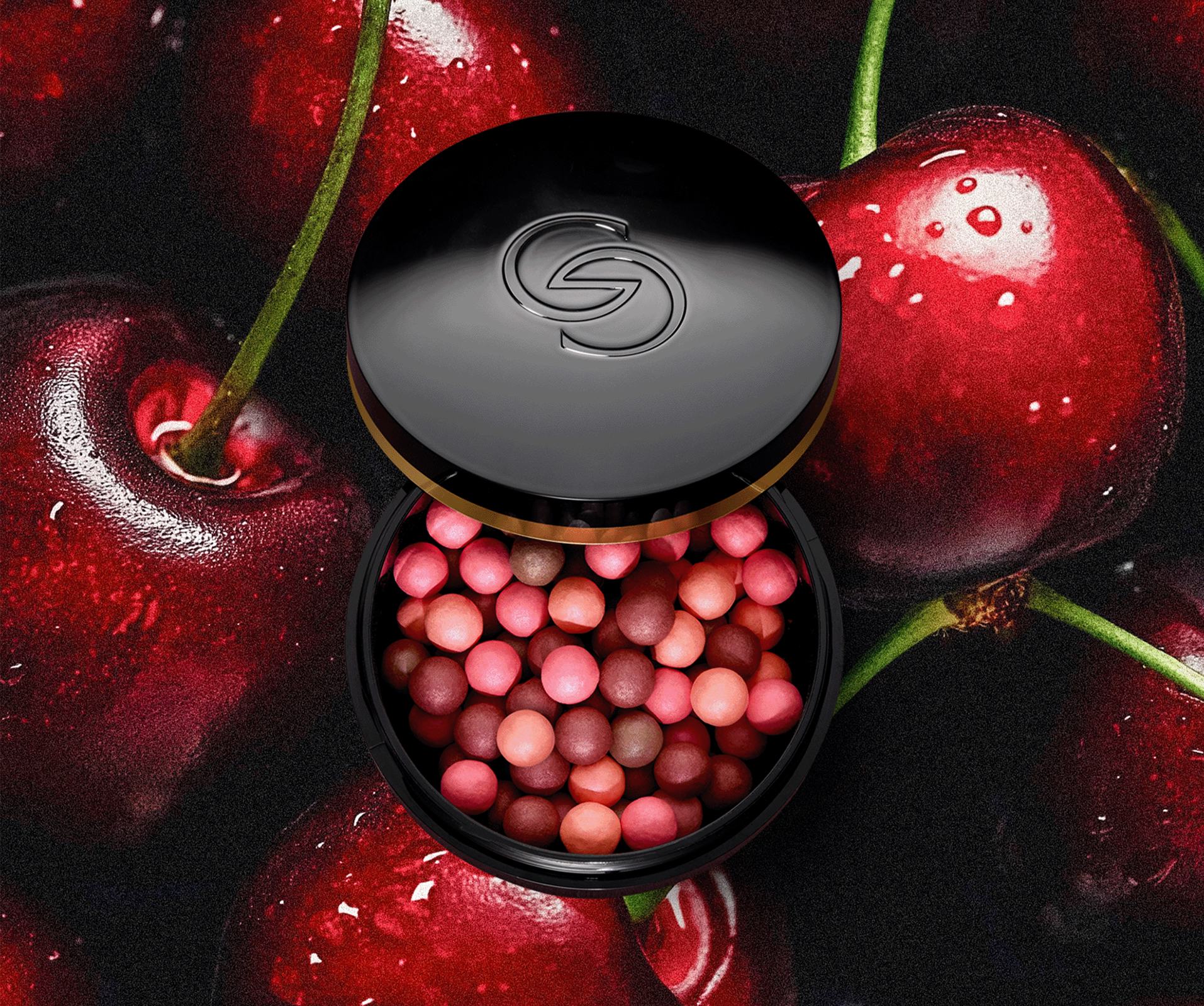 a container of blush on a cherry background