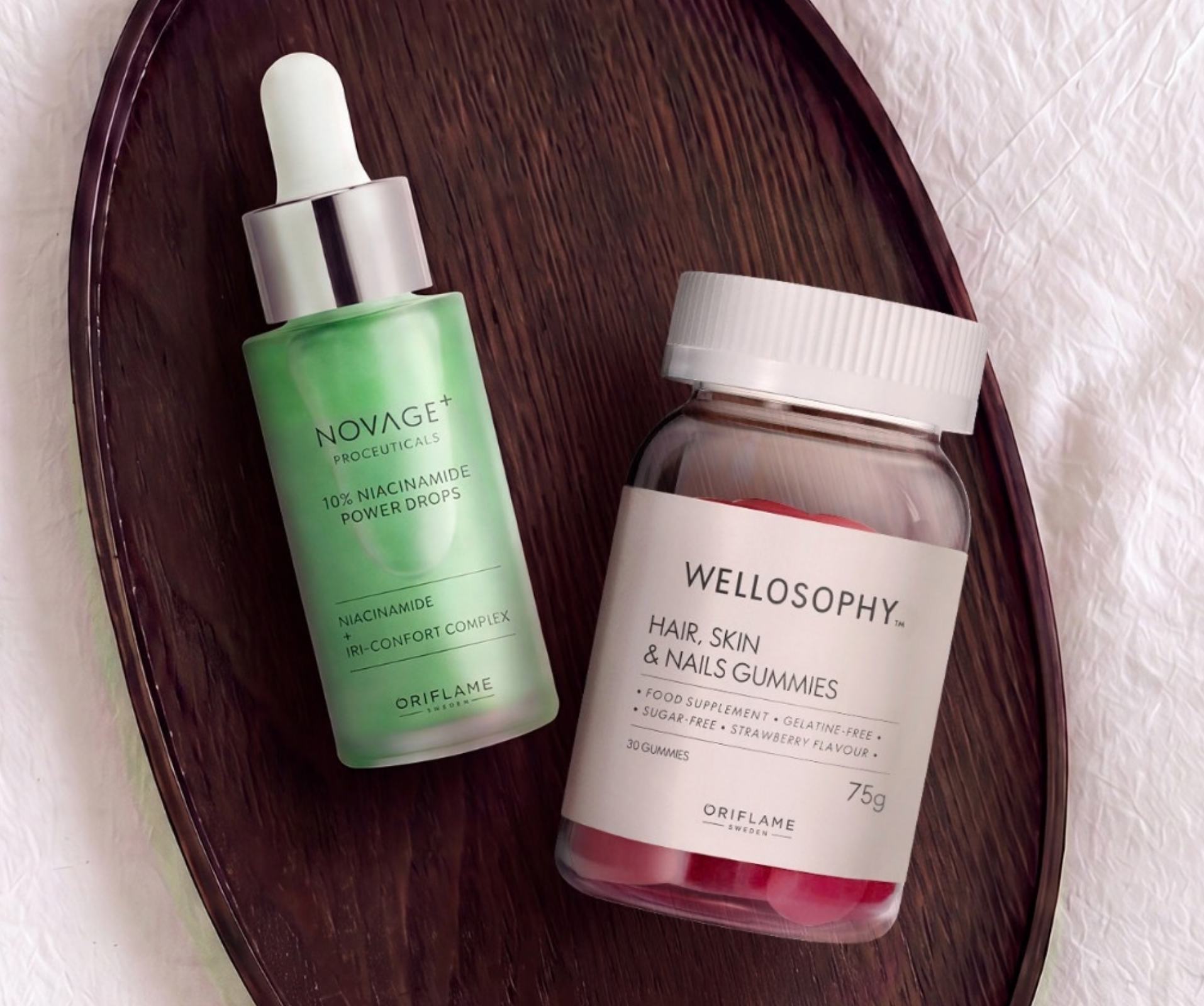 a bottle of beauty products on a wooden tray