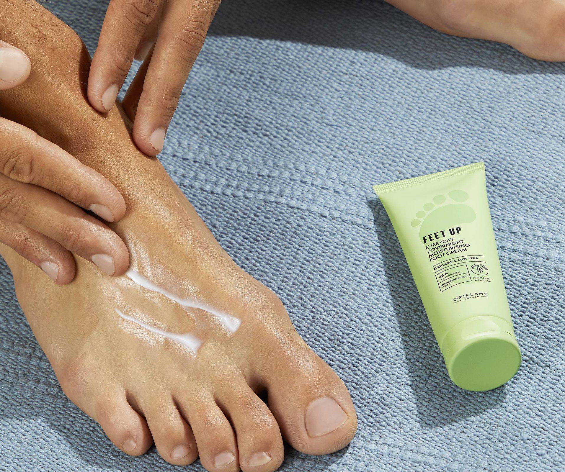 a person applying cream on their foot