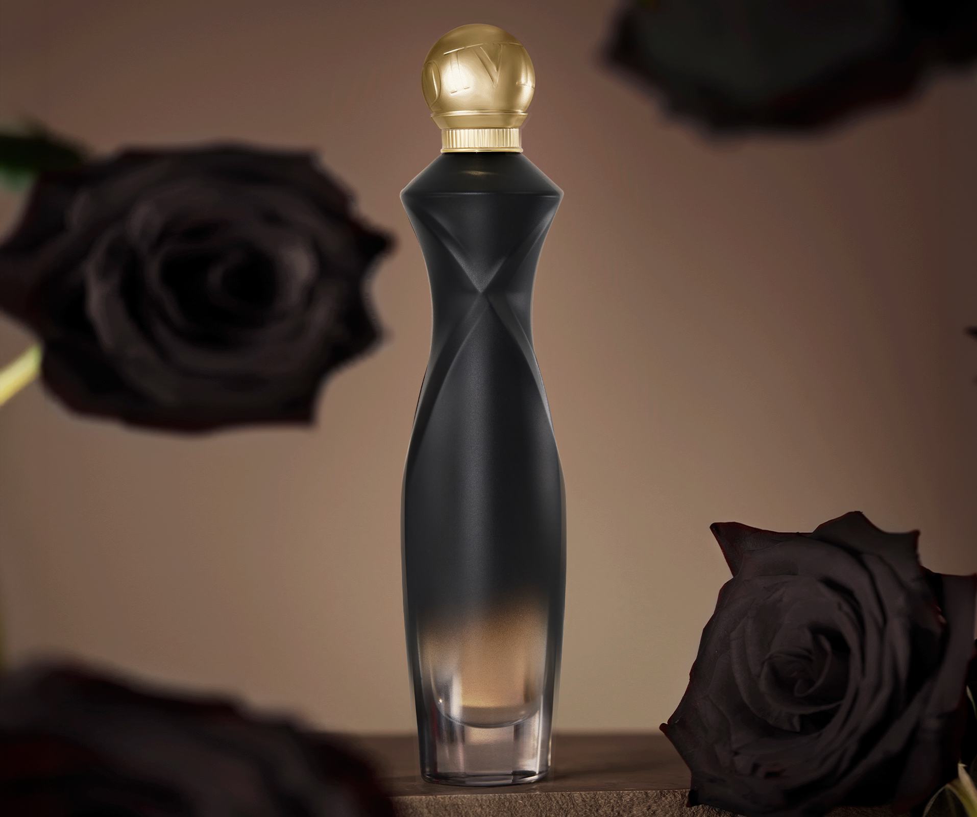 a bottle of perfume with black roses