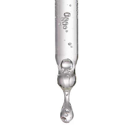 Una gota de agua cayendo de una pipeta.