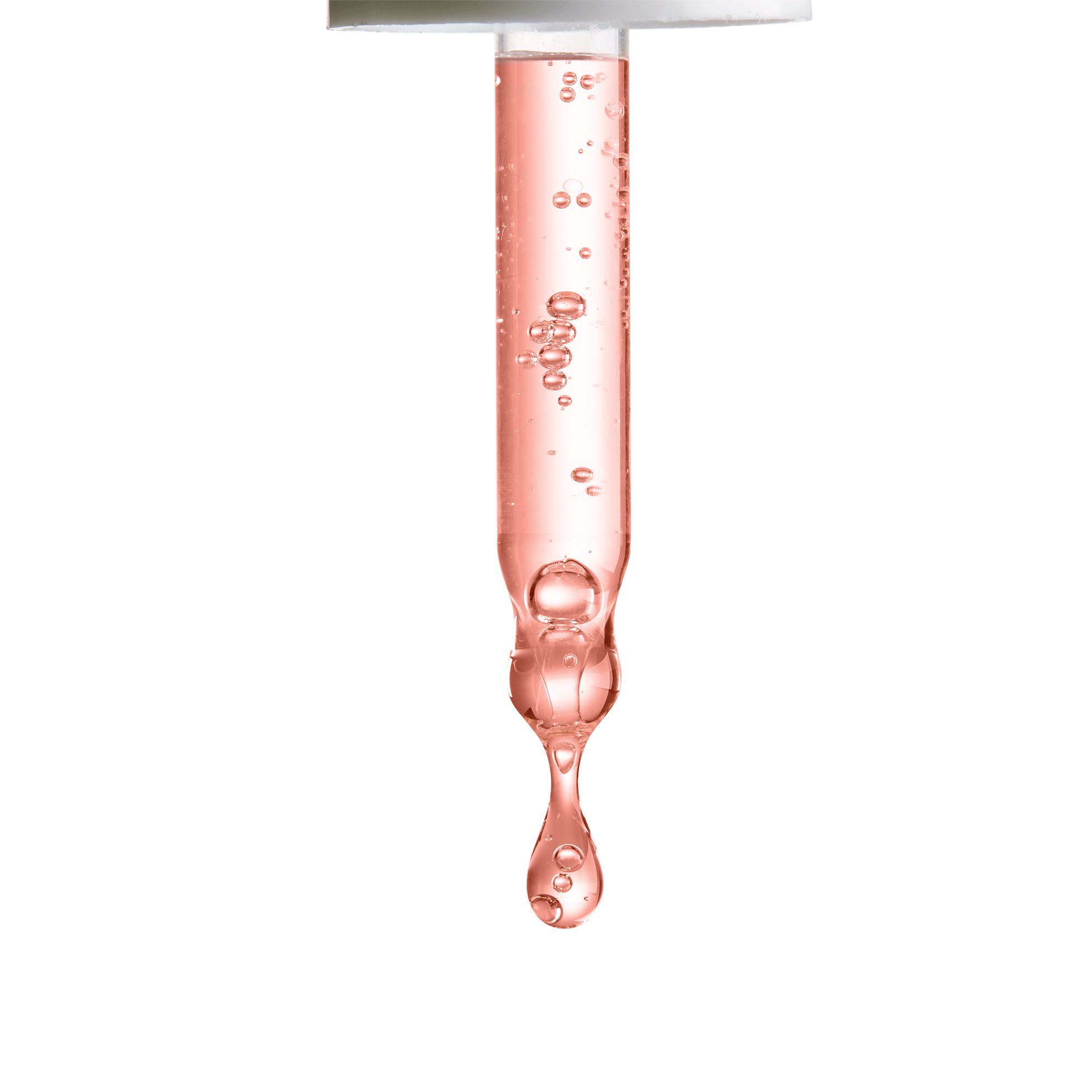 en dråpe rosa væske som drypper fra en pipette