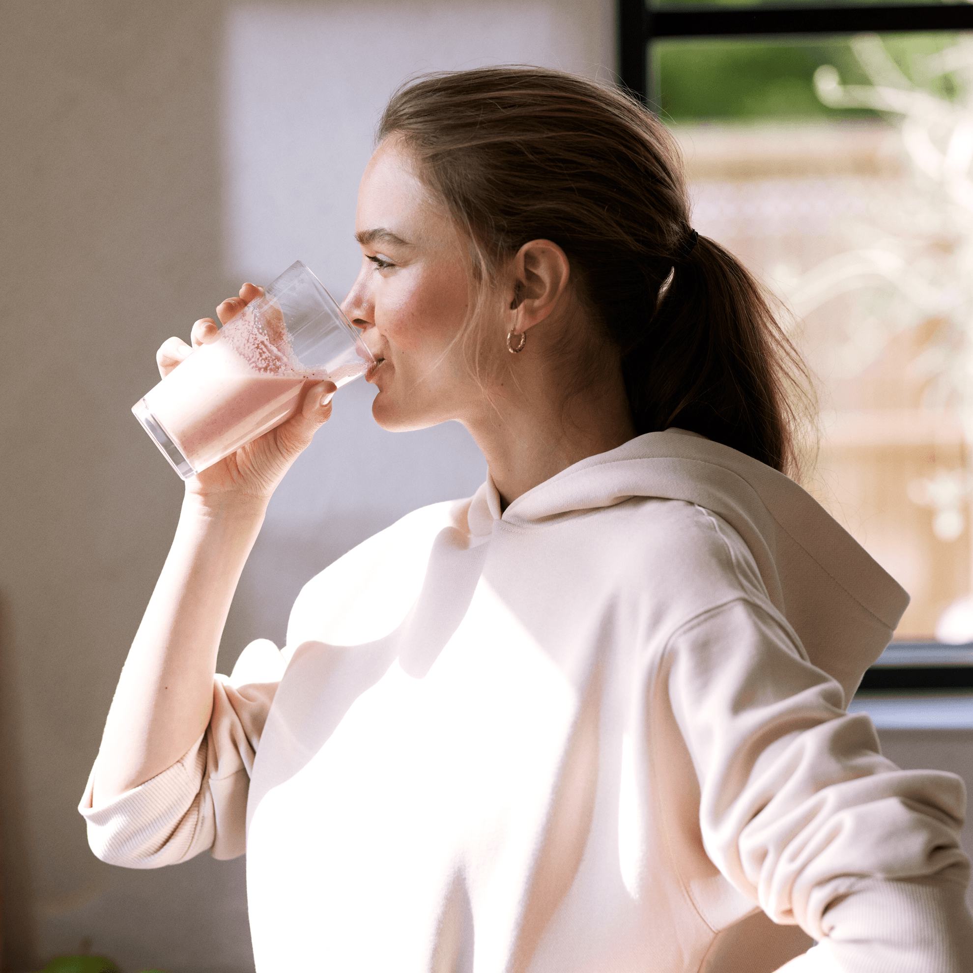 a woman drinking a glass of milk