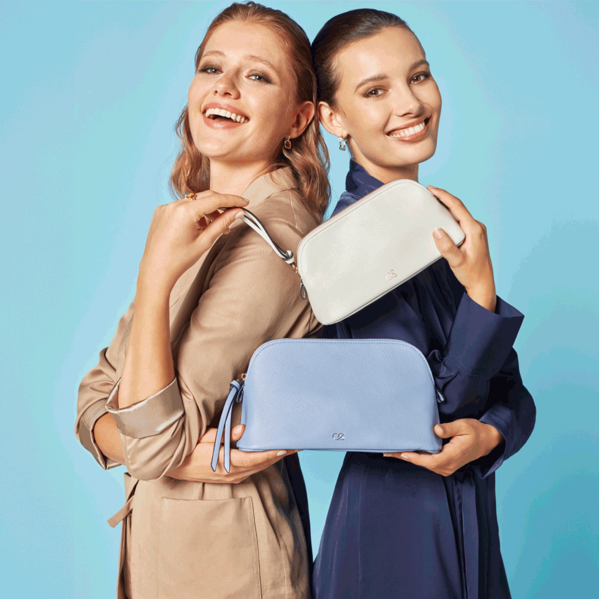 two women holding small purses