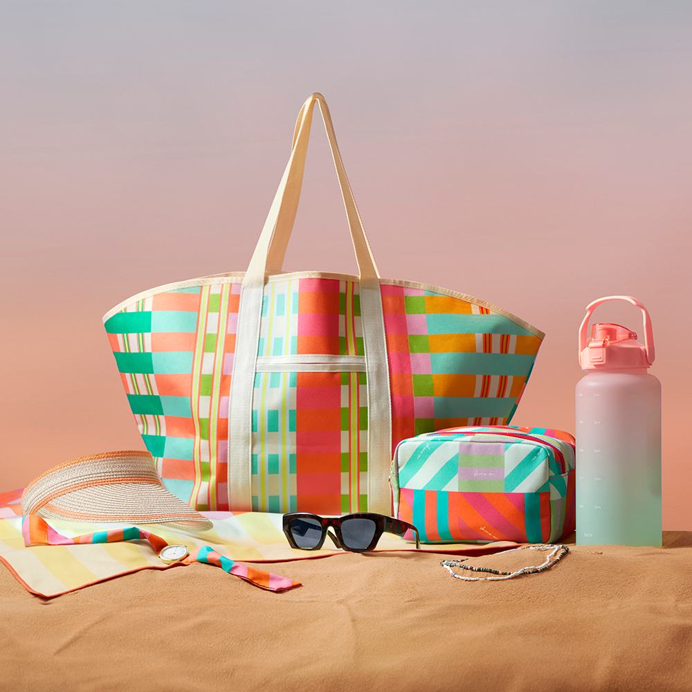 a beach bag and sunglasses on a table