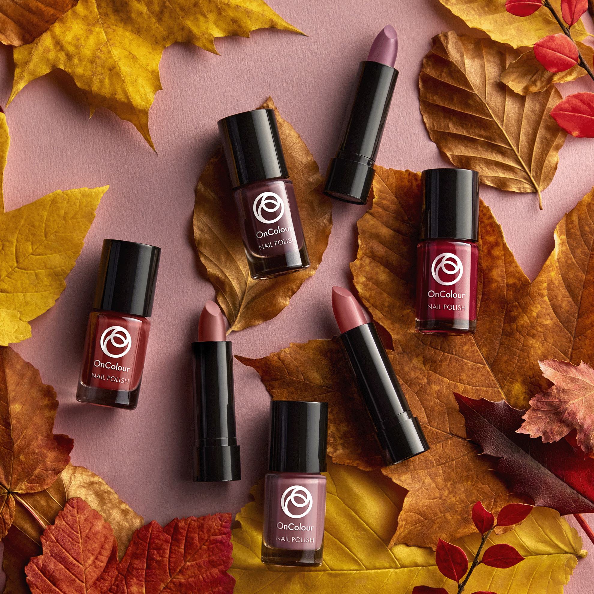 a group of lipsticks and lipsticks on leaves