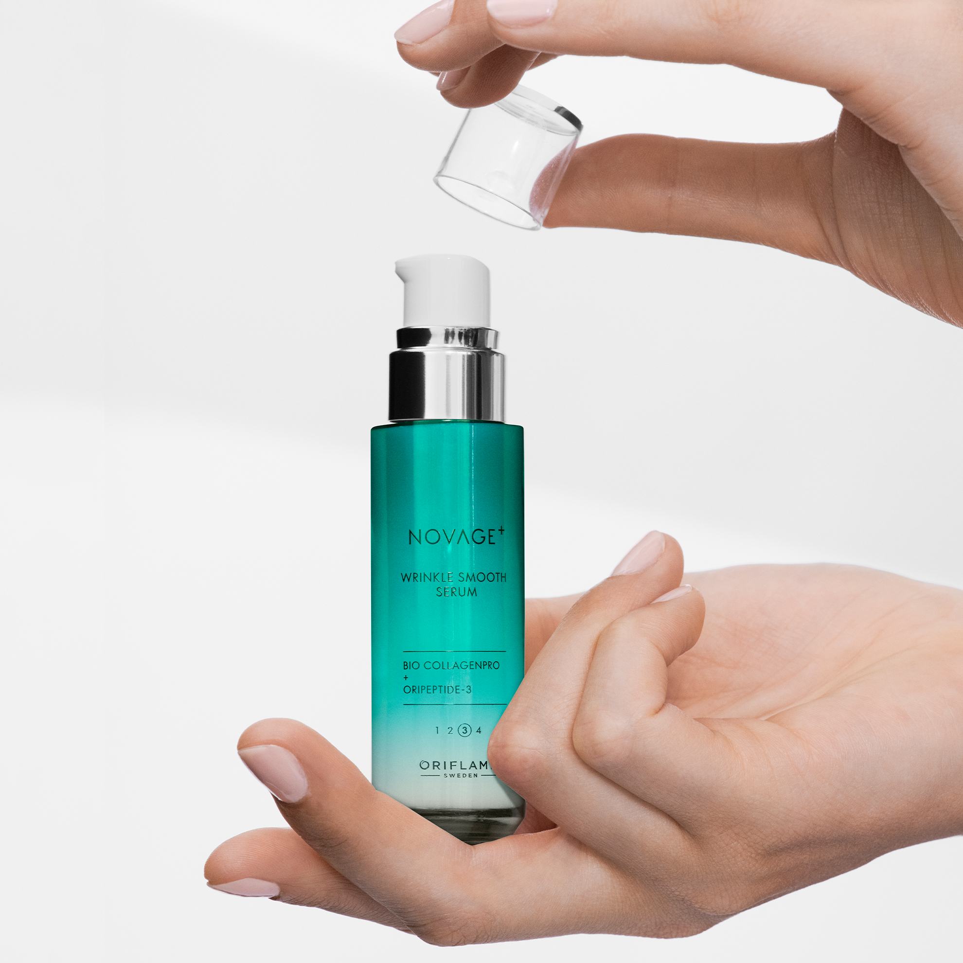 a person holding a small bottle of liquid