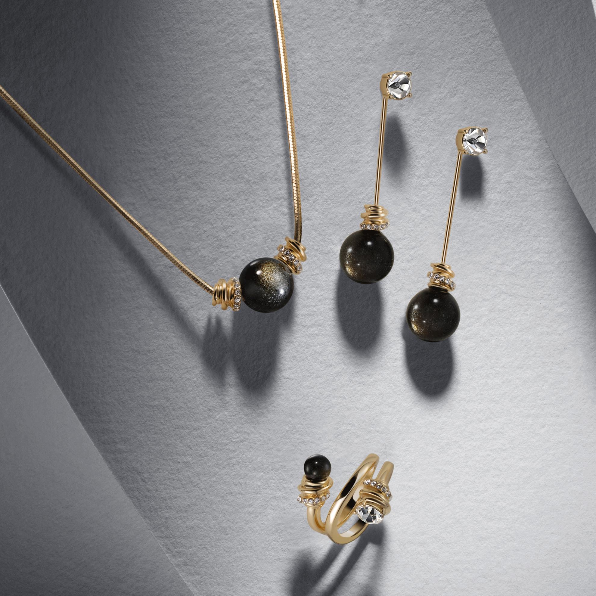 un collar y unos pendientes de oro con piedras negras