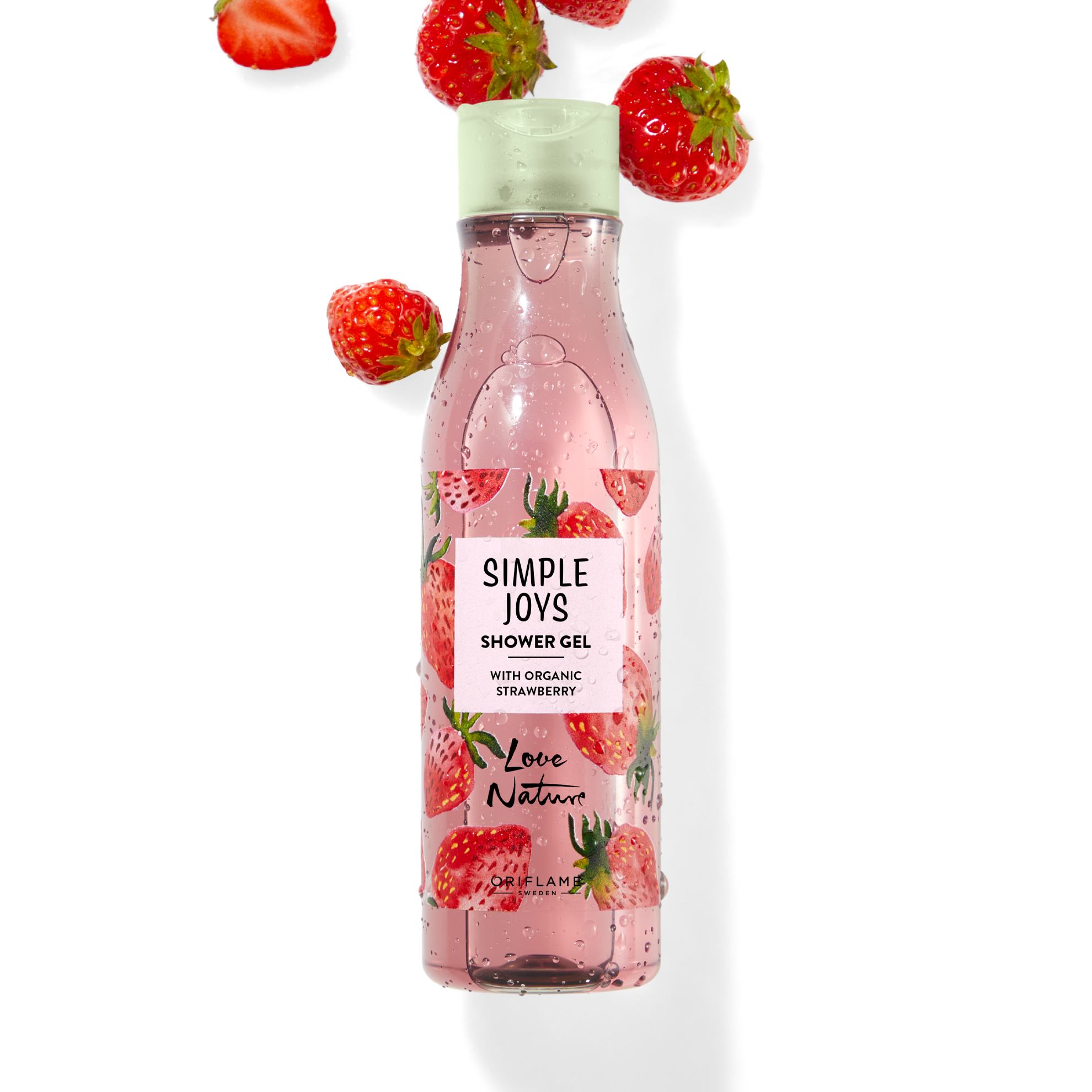 un flacon de gel douche avec des fraises qui tombent