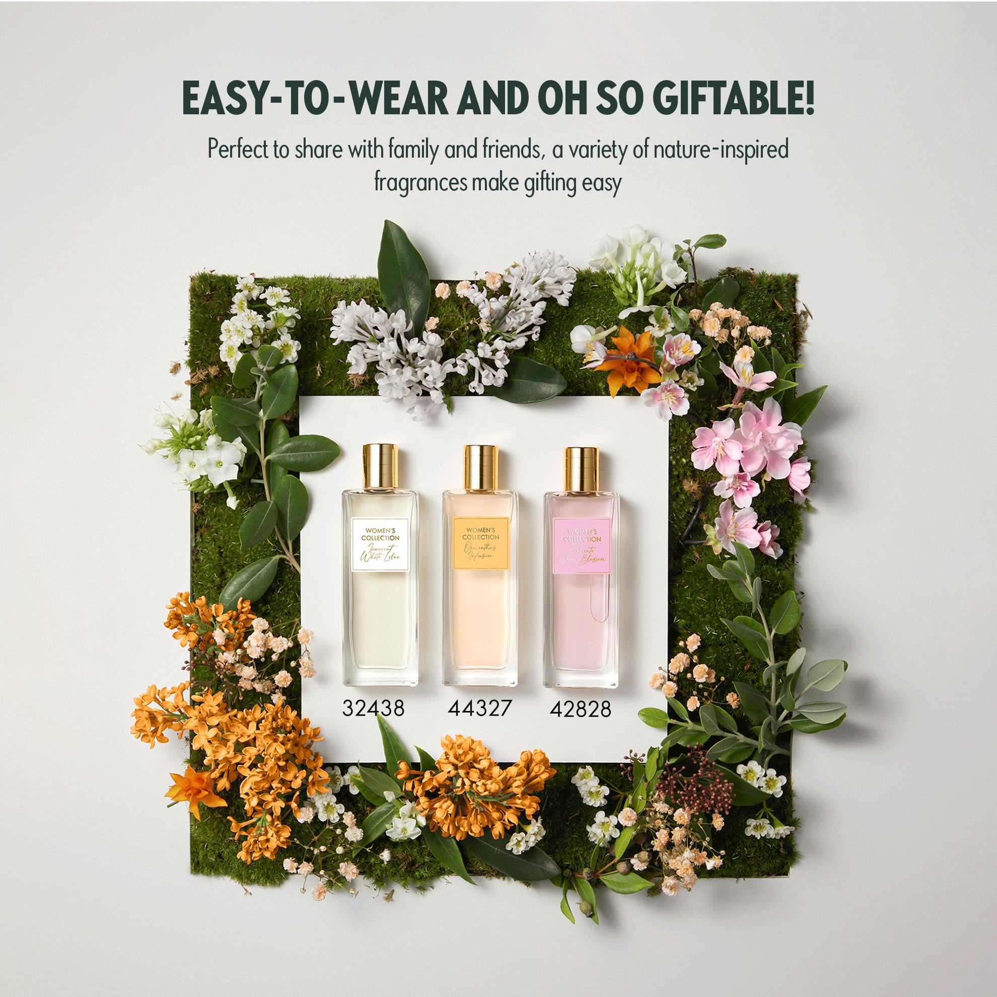 a group of perfume bottles surrounded by flowers