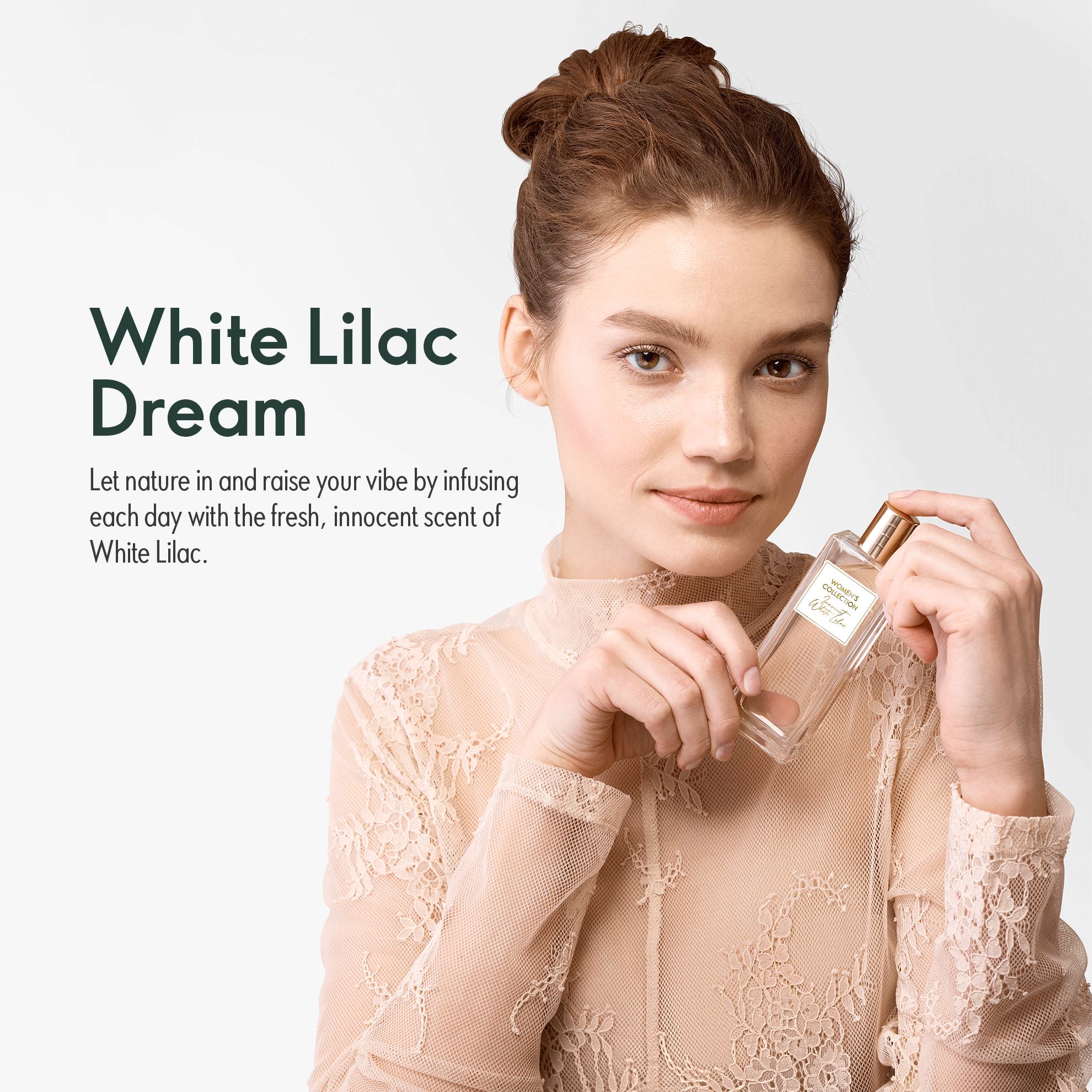 a woman holding a bottle of perfume