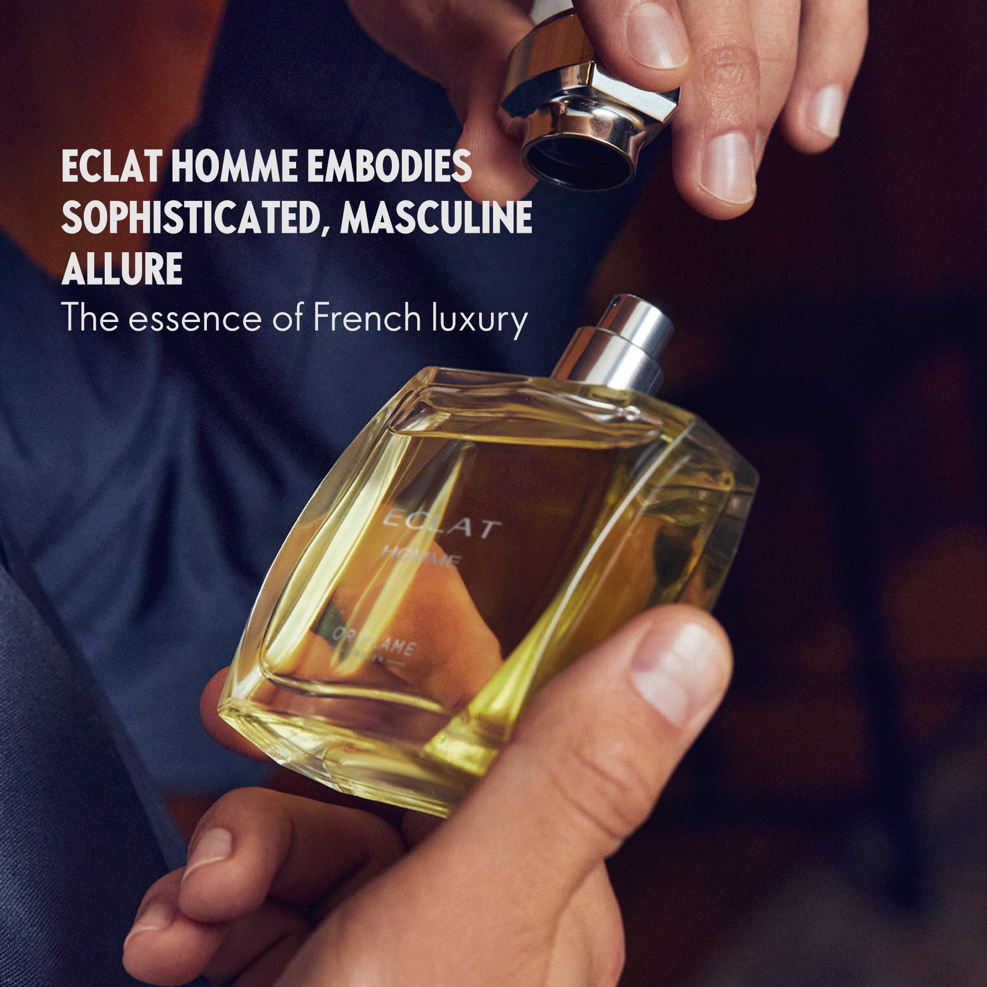 a person holding a bottle of perfume