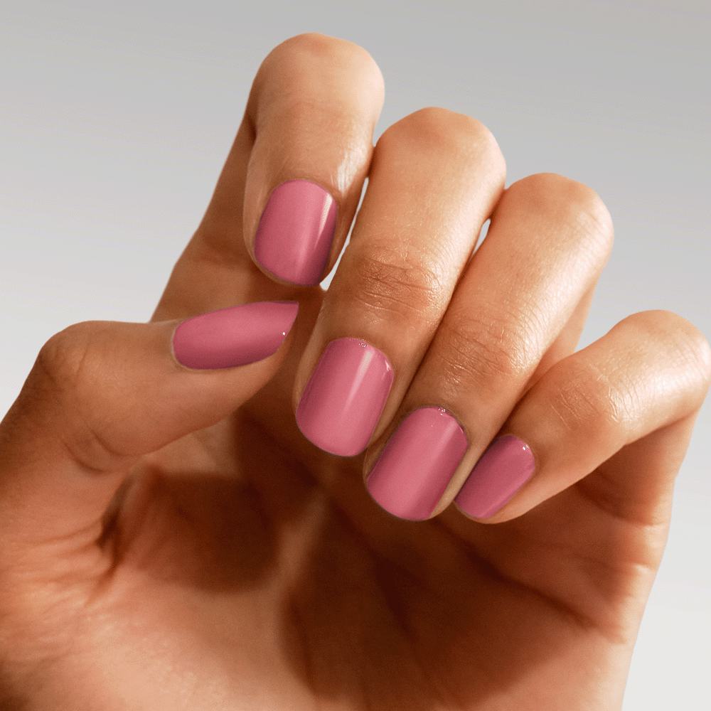 een hand met roze gelakte nagels