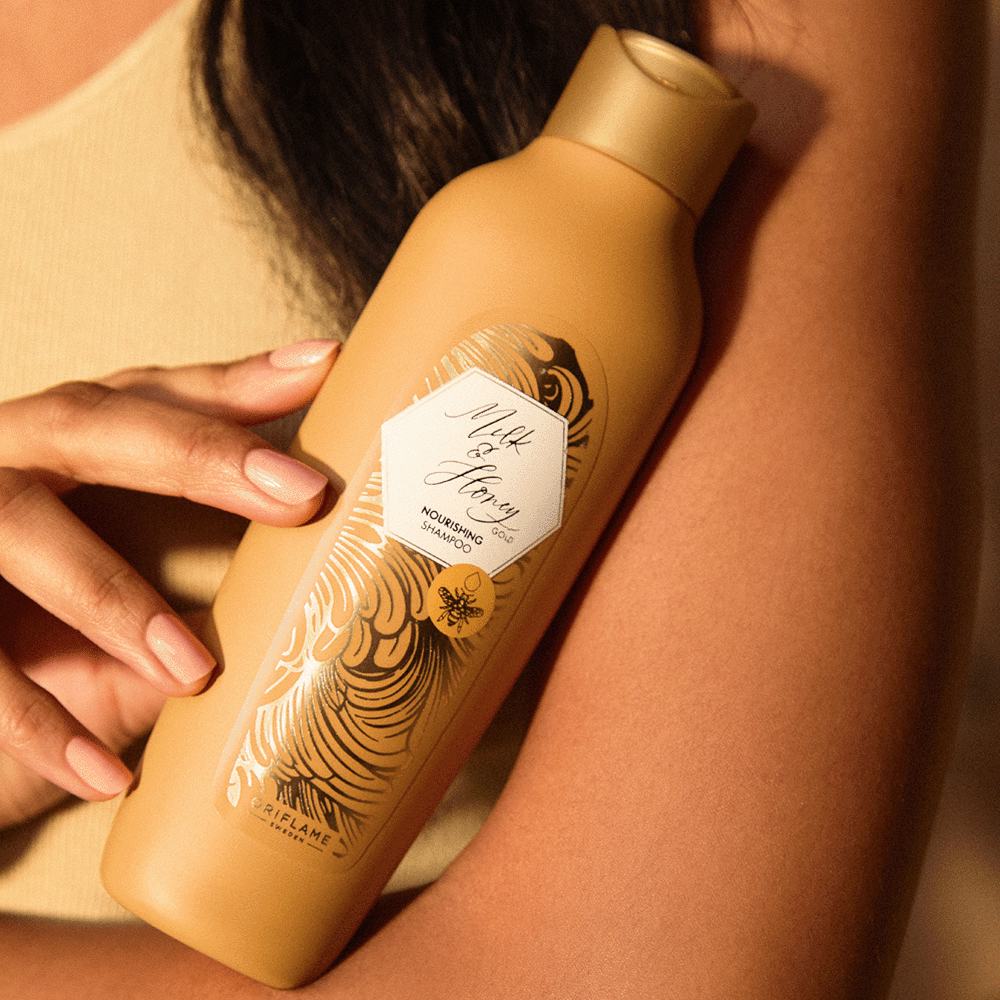 a person holding a bottle of shampoo