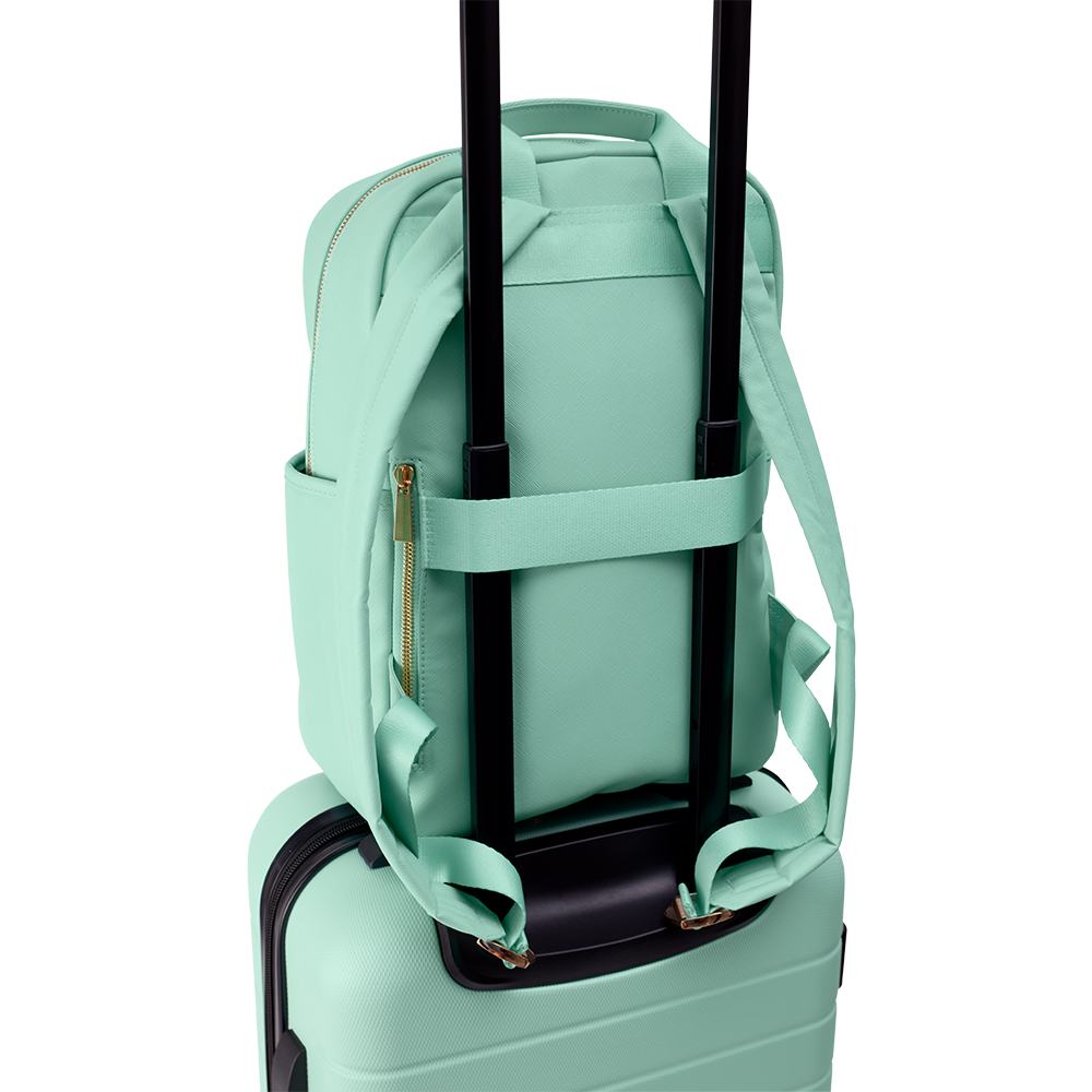 zeleni kofer s crnim ručkama