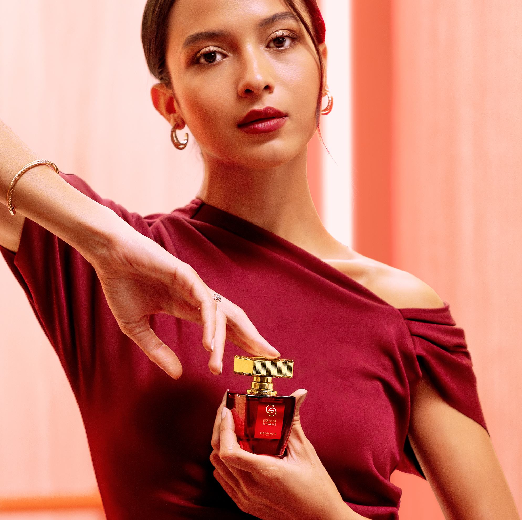 Seorang wanita memegang botol parfum