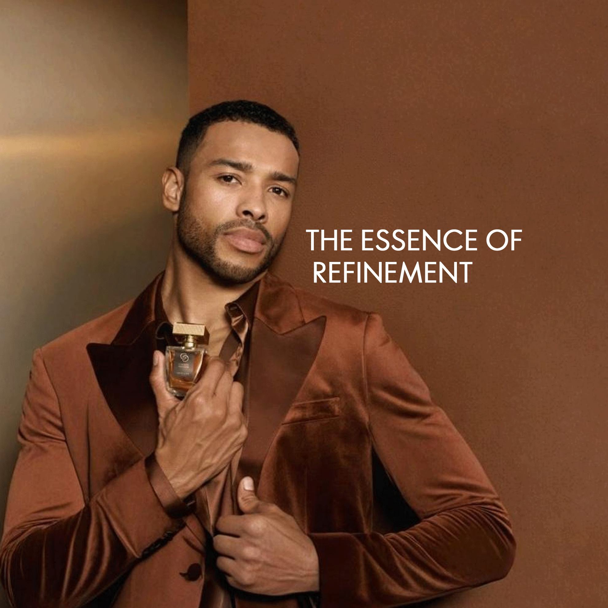 a man holding a bottle of perfume