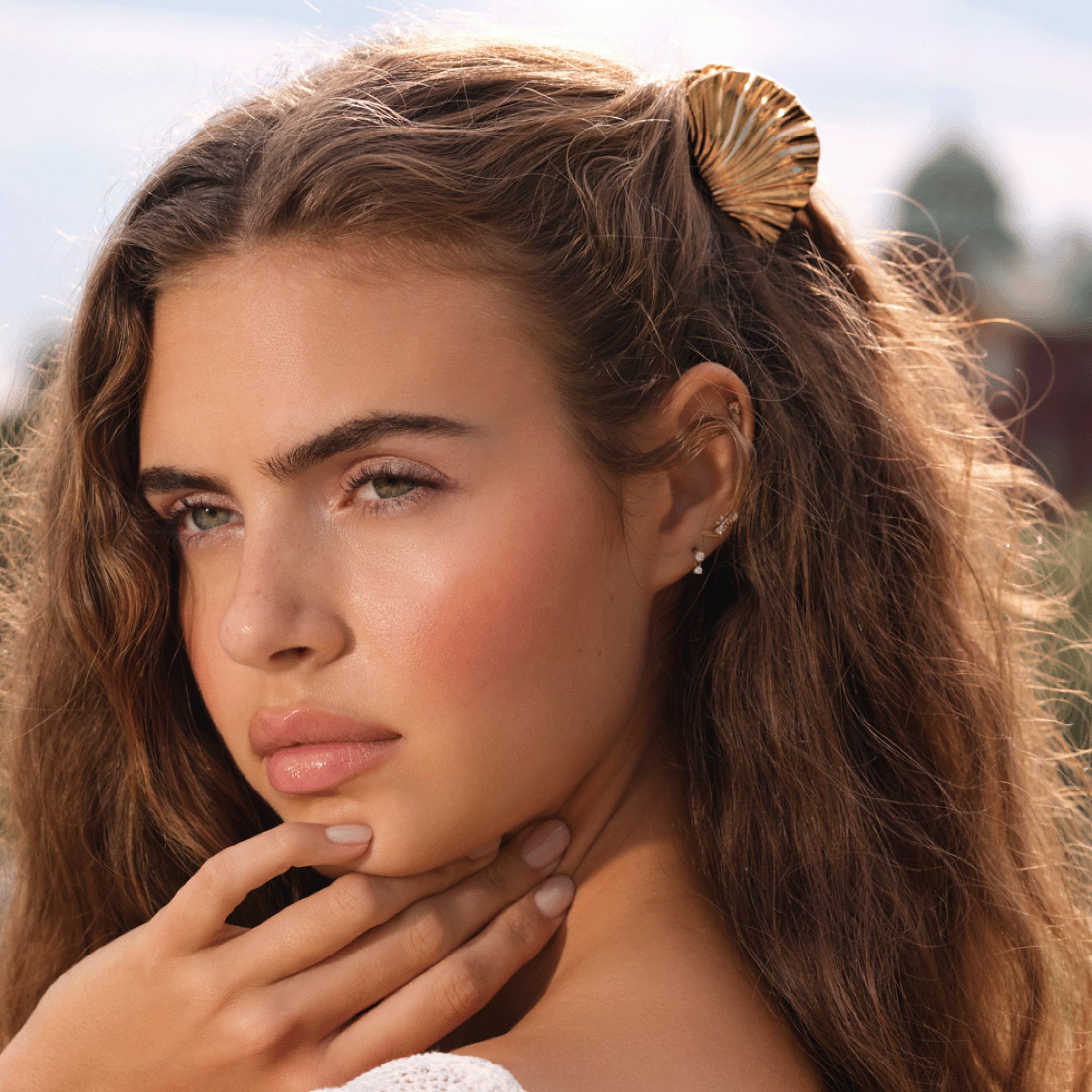 a woman with a shell in her hair
