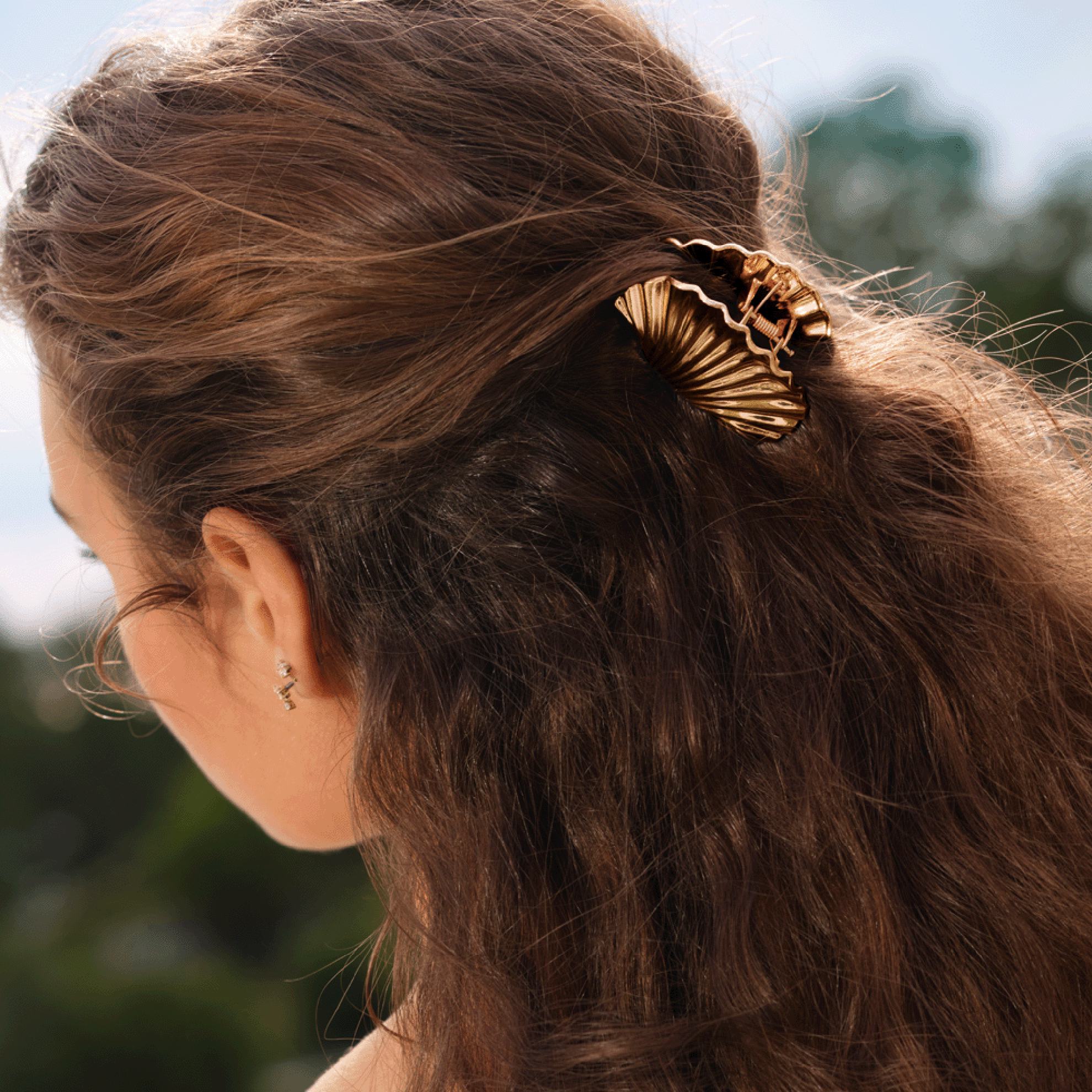 a woman with a gold hair clip