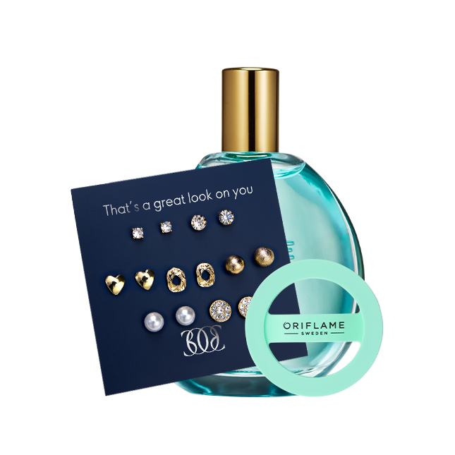un frasco de perfume con una tarjeta y unos pendientes
