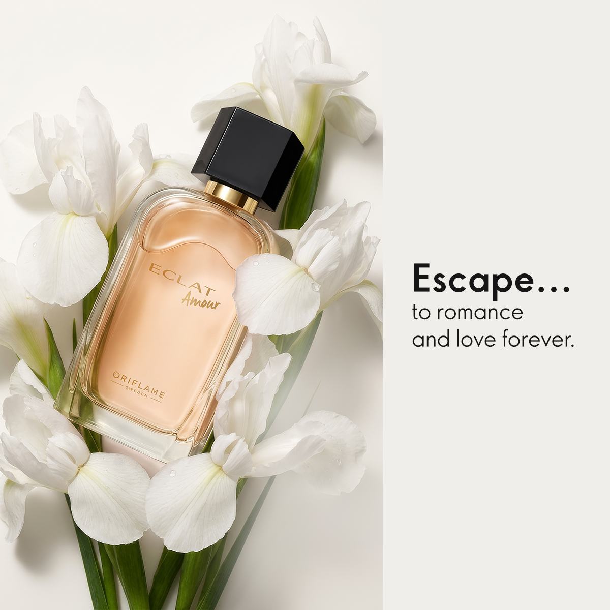 a bottle of perfume surrounded by white flowers
