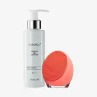 a white bottle with a silver lid next to a pink round device