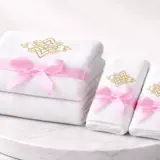 une pile de serviettes blanches ornées de nœuds roses