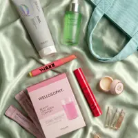 a group of cosmetics on a green fabric