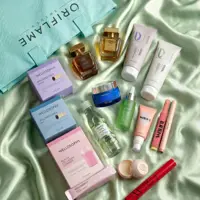 a group of cosmetic products on a green fabric
