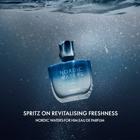 a bottle of perfume under water