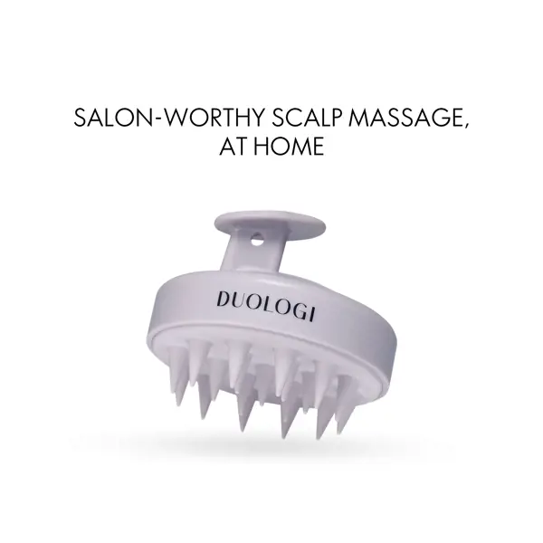 a white massage brush with a handle