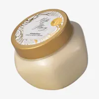 Un tarro de crema con tapa dorada.