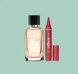 dudak parlatıcısının yanında bir parfüm şişesi