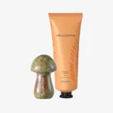 un frasco de crema junto a una estatua de piedra