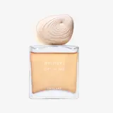 un frasco de perfume con un objeto blanco encima