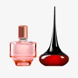 un frasco de perfume junto a un frasco negro y rojo