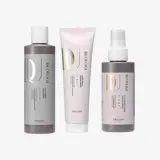 Un grupo de botellas de champú y un tubo de crema.