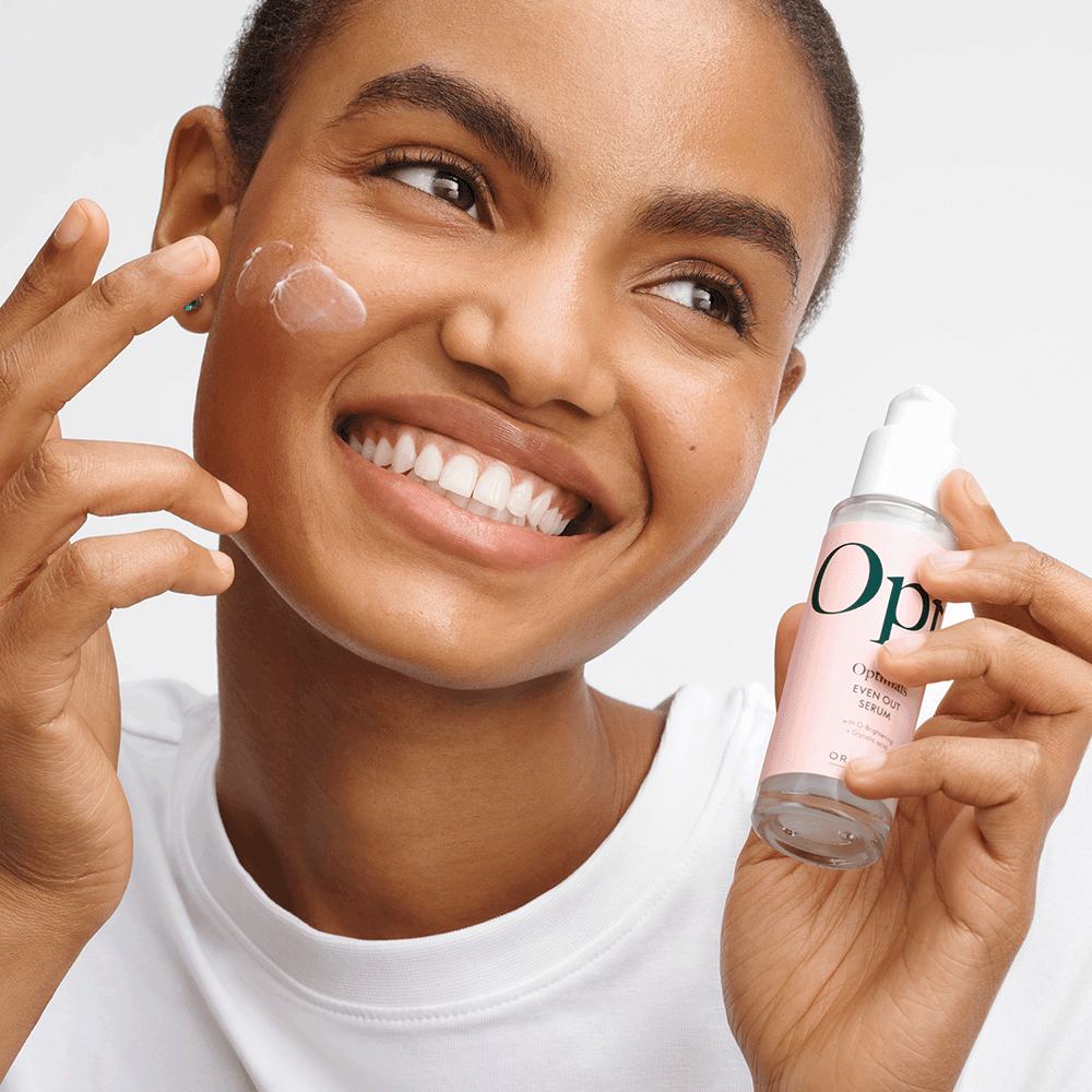 a woman applying a cream on her face