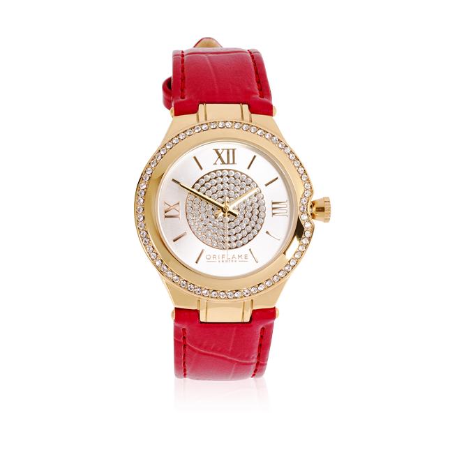 Un reloj dorado y rojo con correa de cuero roja.