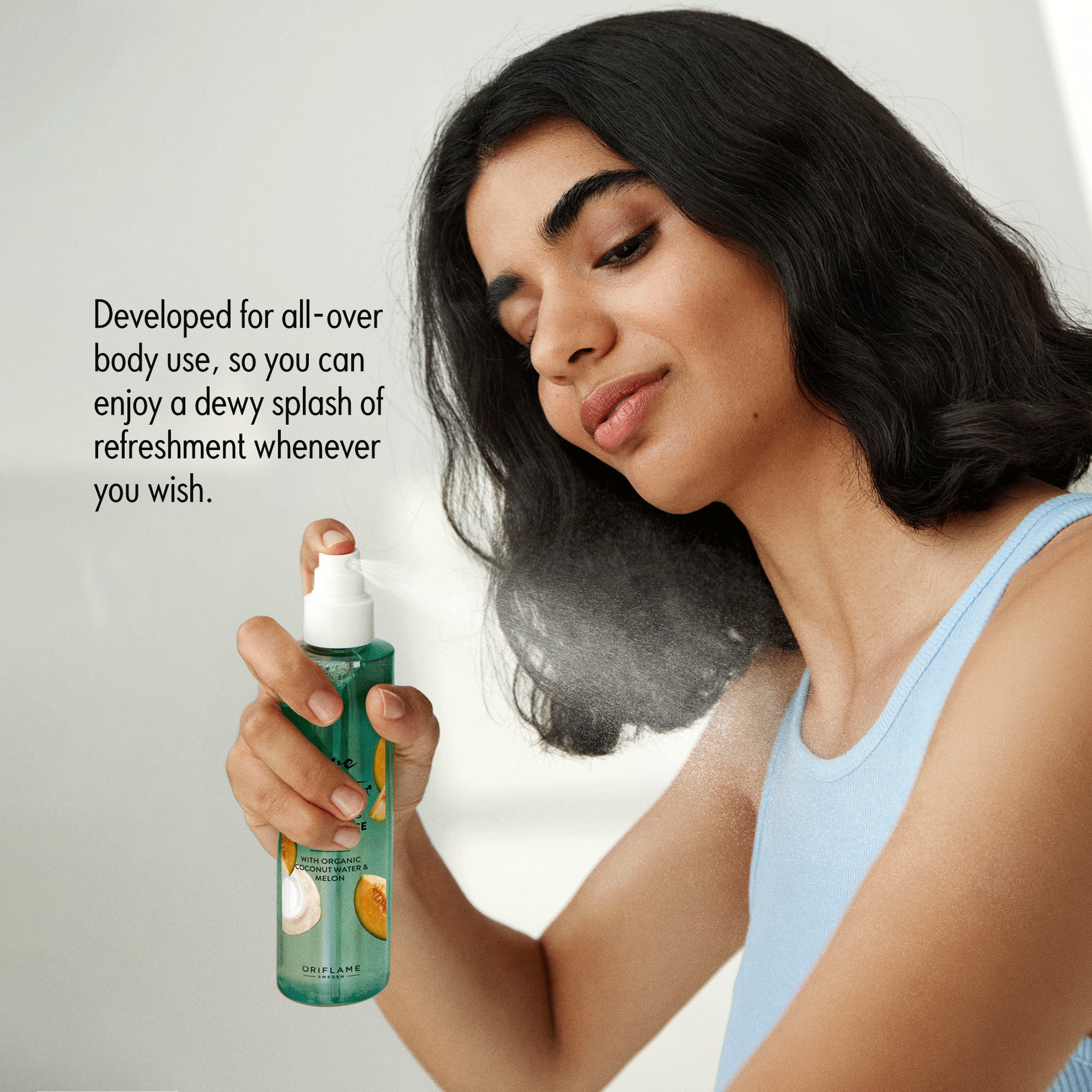 a woman spraying a body using a spray bottle