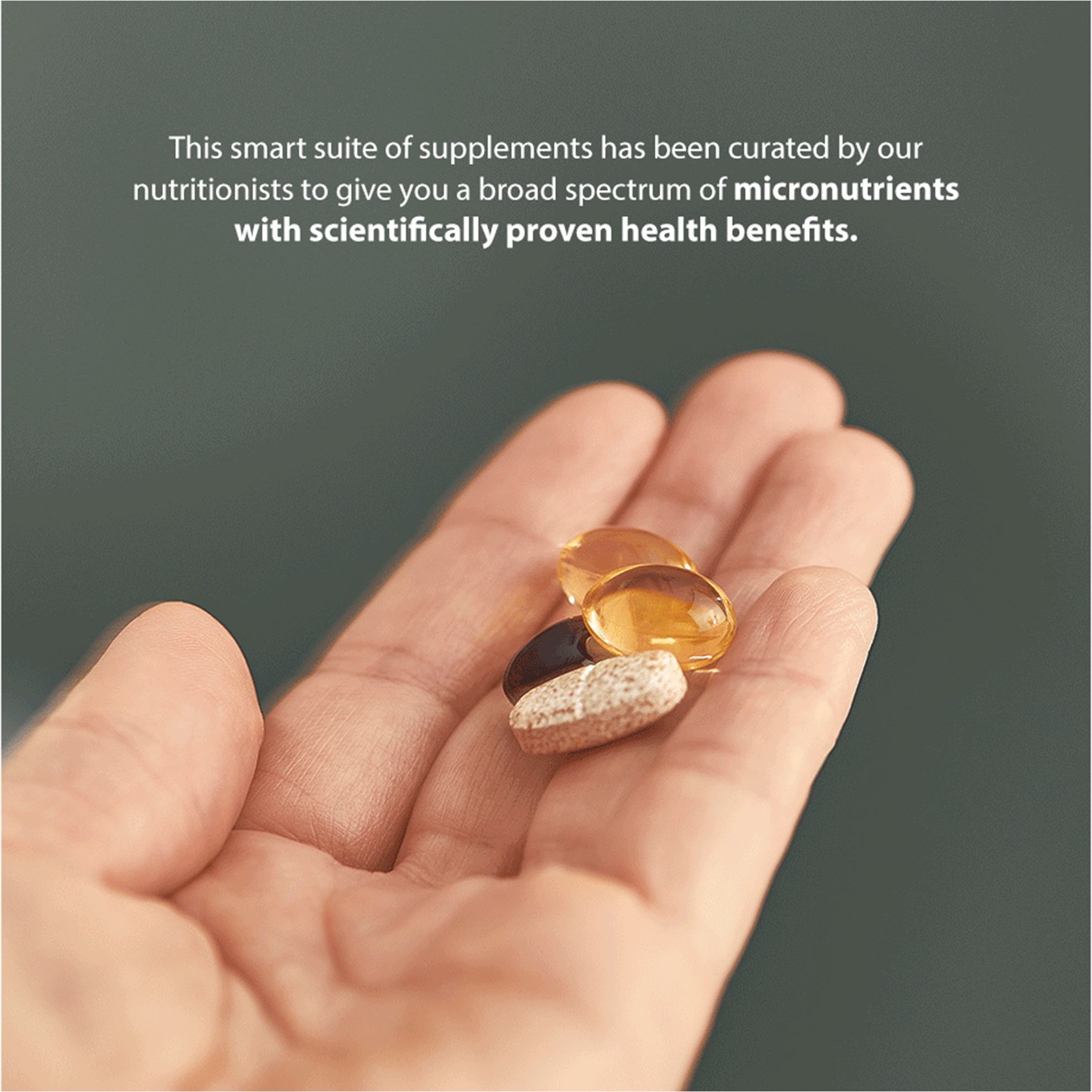 a hand holding a few pills