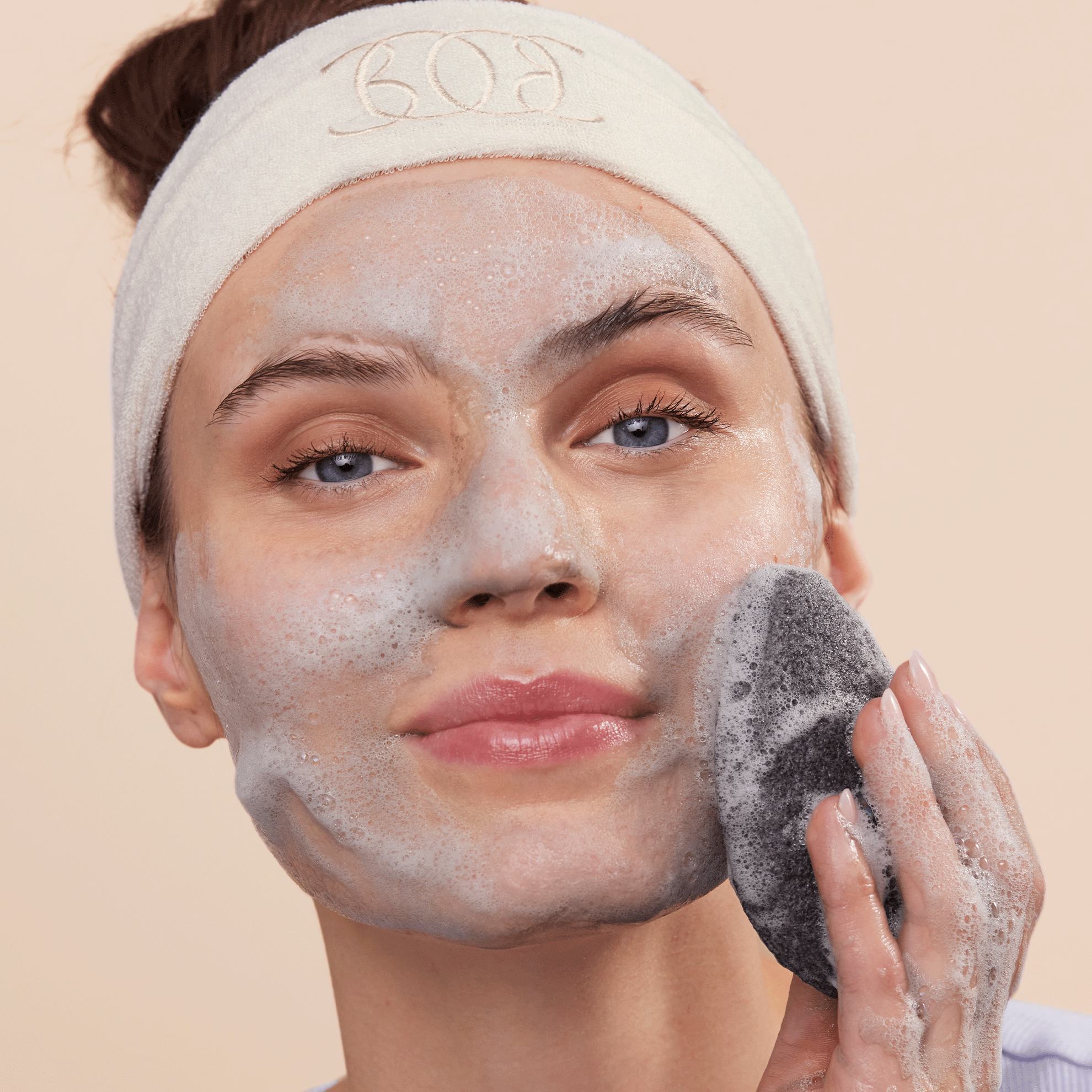 a woman with a sponge on her face