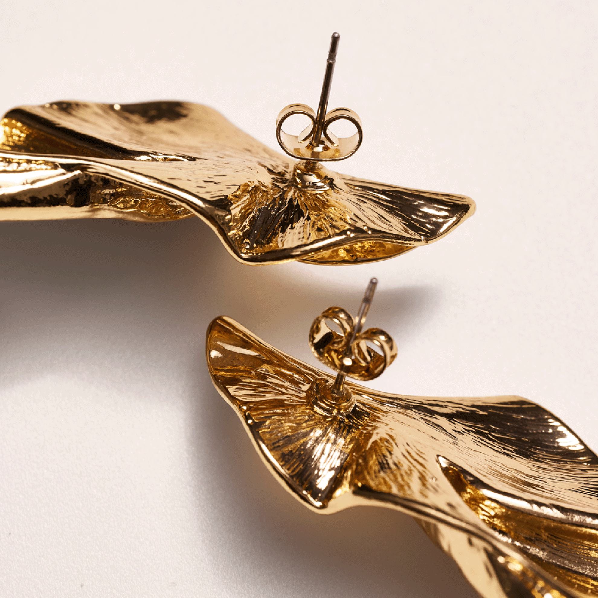 a pair of gold earrings