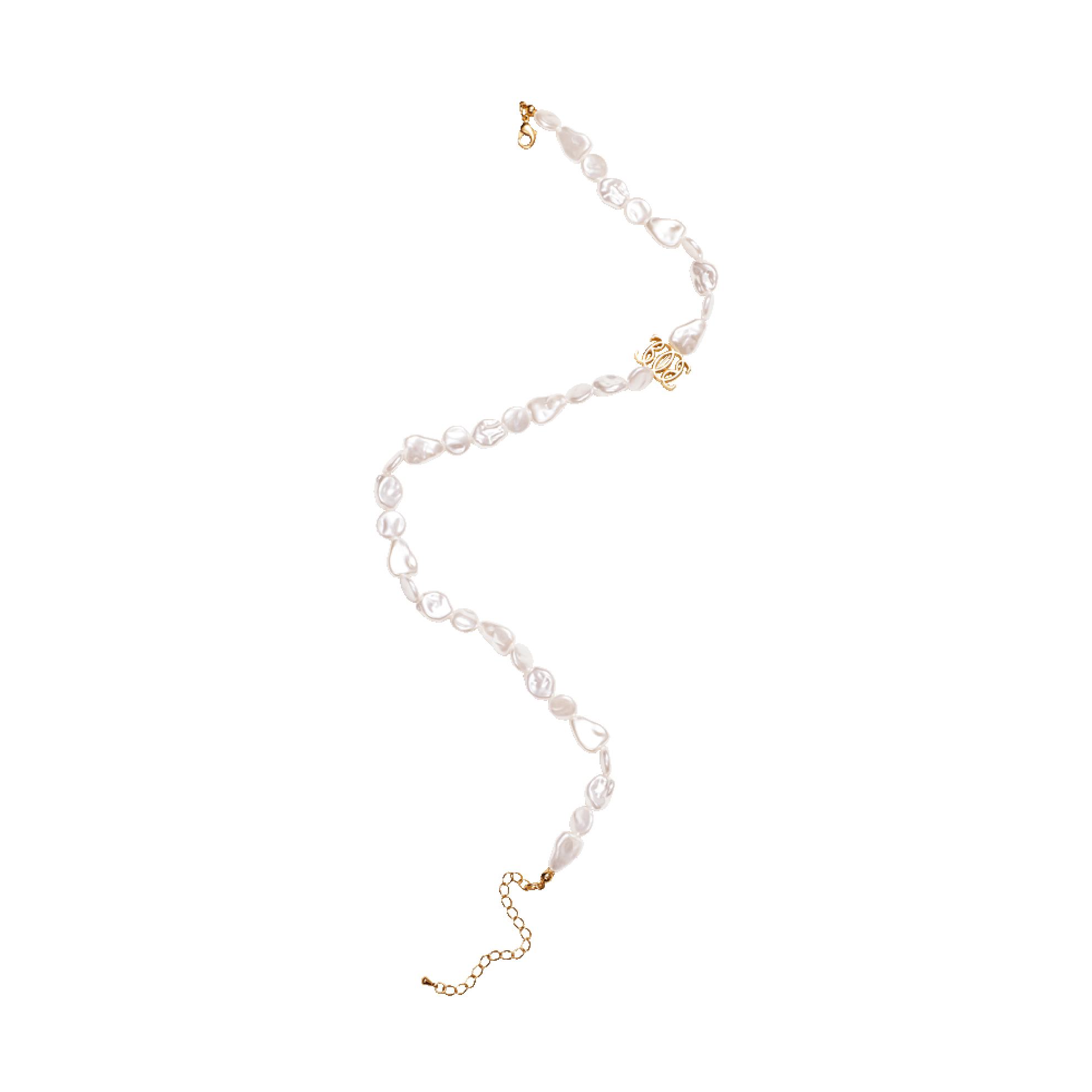 a white pearl necklace with gold accents